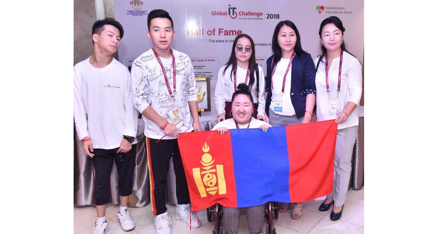 A group photo of the Mongolian participants holding up their national flag