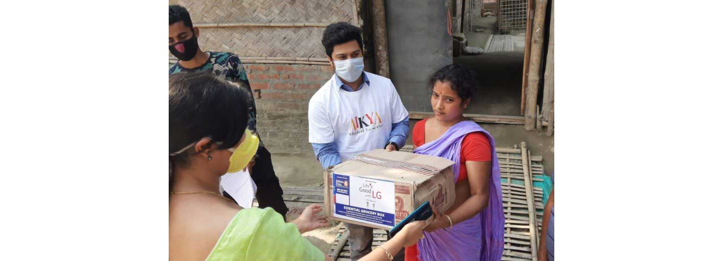 A man and woman in India gifting LG products to others