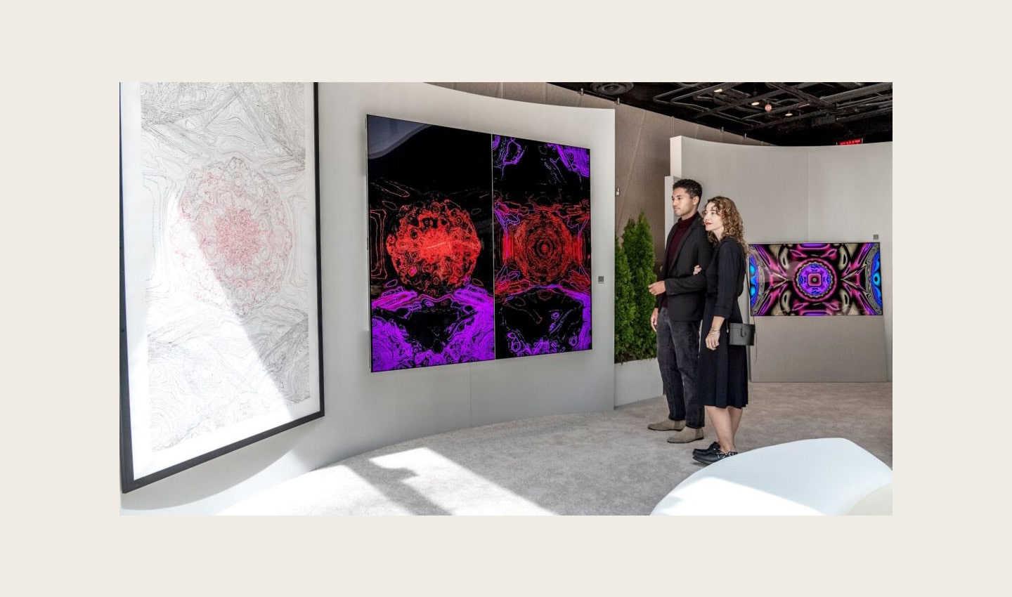 Two visitors viewing Kevin McCoy's work of art displayed on LG OLED TV