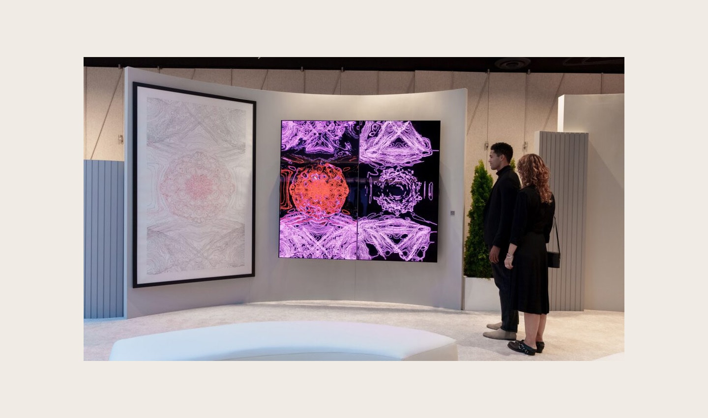 Two visitors viewing Kevin McCoy's work of art displayed on LG OLED TV