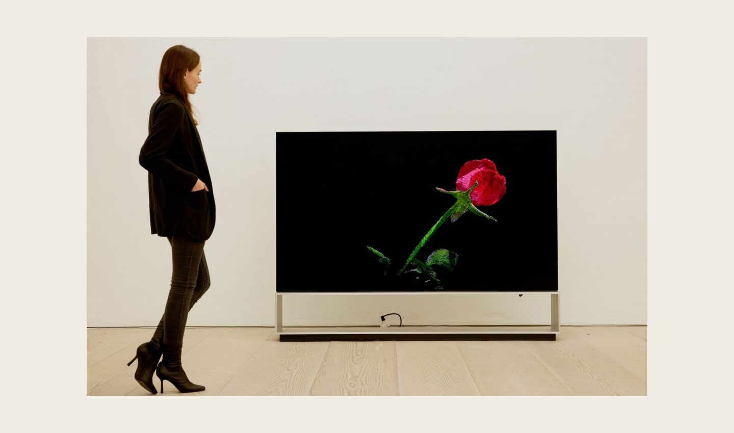 A visitor viewing ‘The Moment & Morpho Luna’ by Je Baak displayed on the LG OLED TV