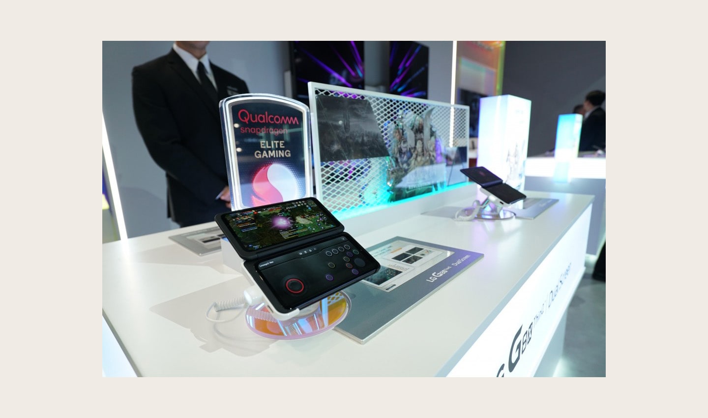 A close-up of two LG G8X smartphones strapped into LG Dual Screen on display in front of a Qualcomm Snapdragon Elite Gaming sign at CES 2020