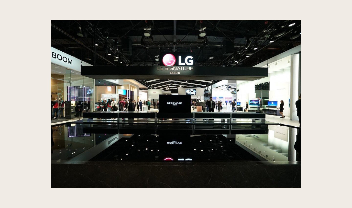 The front of the LG SIGNATURE OLED Zone with ten LG SIGNATURE Rollable TVs displayed, one in full view mode and the others concealed in their boxes