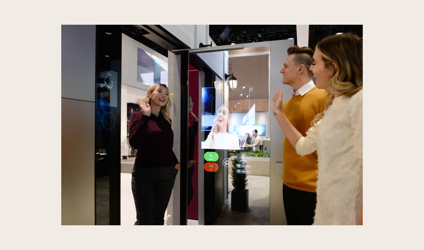 A visitor waves to her friends after using LG ThinQ’s Smart Door concept which was showcased at CES 2020