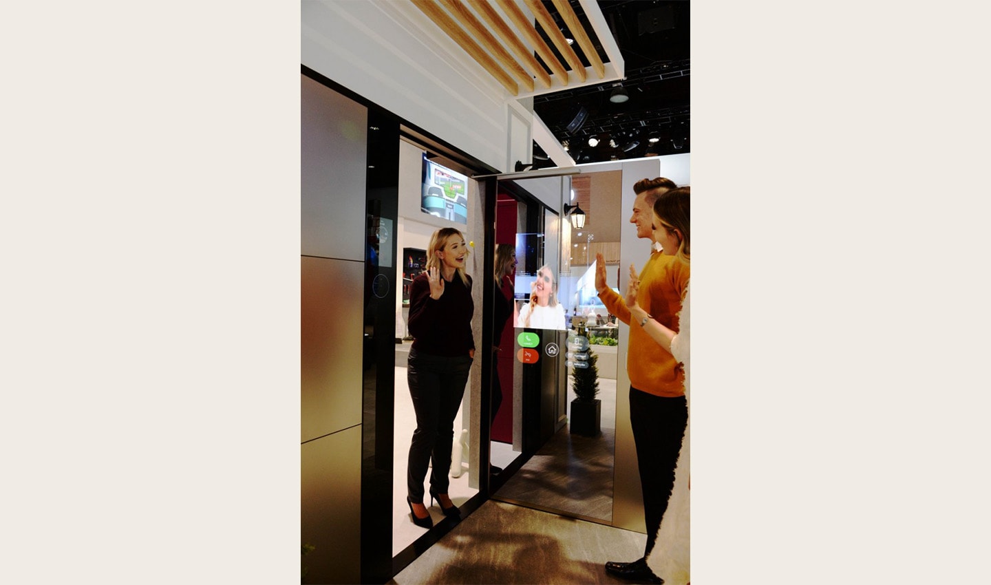 Another view of a visitor waving to her friends after using LG ThinQ’s Smart Door concept which was showcased at CES 2020