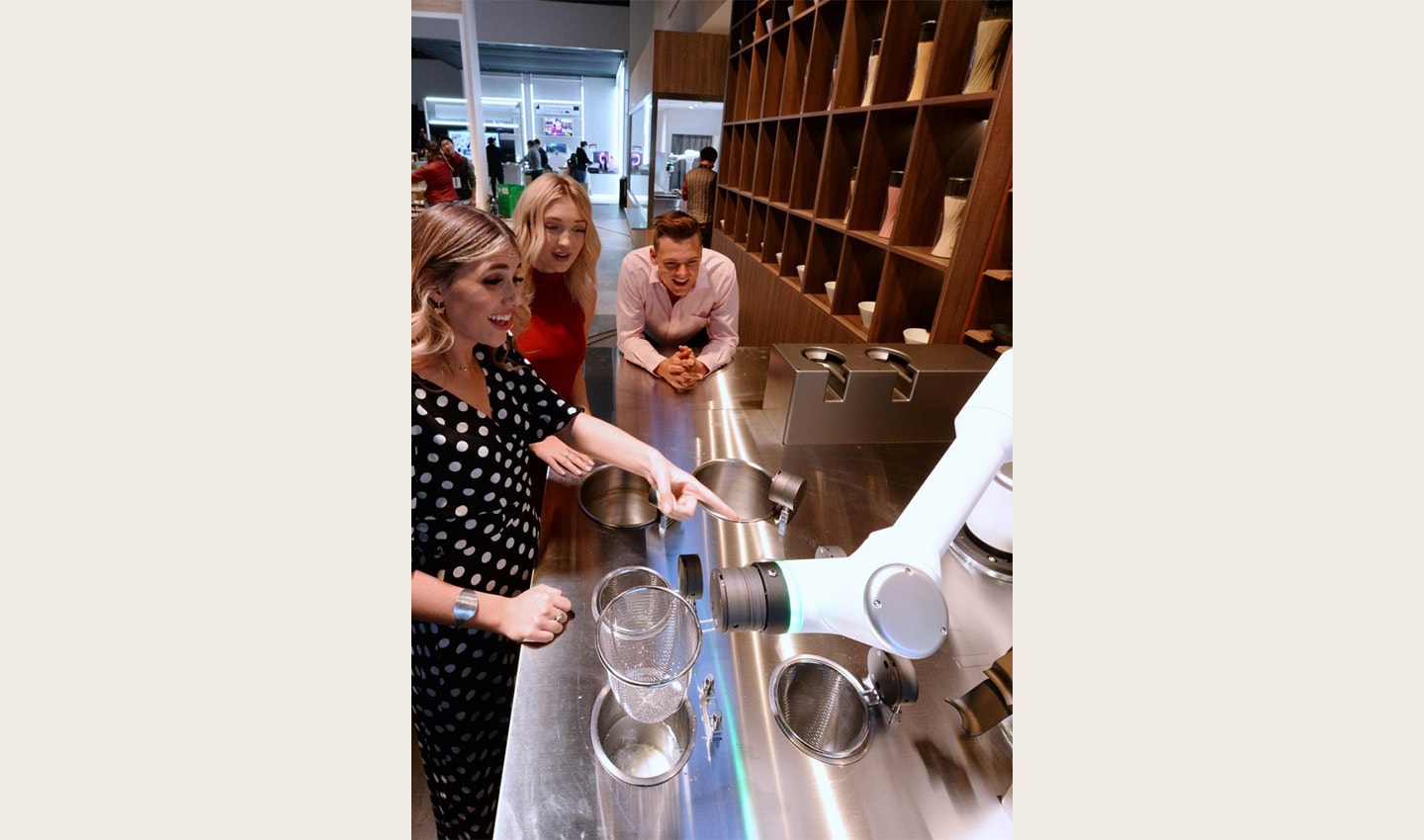 Visitors to the ‘ClOi’s Table’ restaurant watch on as one of LG’s CLOi CoBots prepares their meal