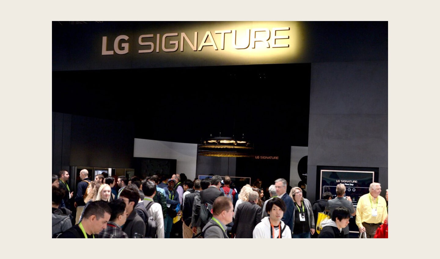 Conference attendees walk around the LG SIGNATURE display zone at CES 2019.