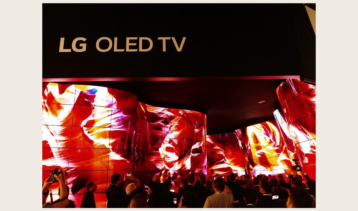 People standing before the entrance of the LG OLED Canyon and taking photos, LG OLED TV sign is visible above the canyon.