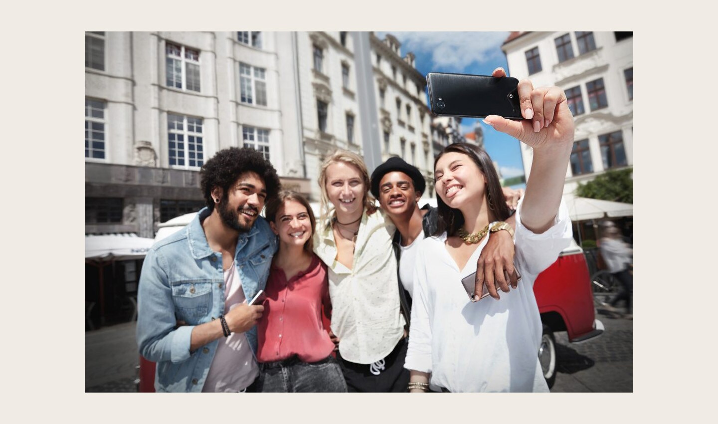 A group of friends uses the LG Q6 phone to take a selfie