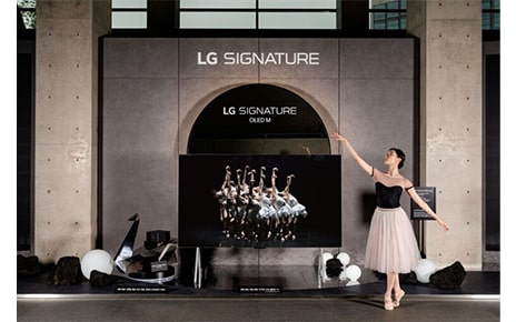   A ballerina posing next to LG SIGNATURE OLED M installed at LG Arts Center SEOUL