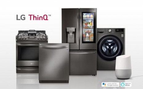 LG smart appliances lineup including refrigerator, front-load washing machine, oven and dishwasher with the SmartThinQ™ logo on the upper left. Google Home, an AI speaker with Google Assistant standing along with LG smart appliances.