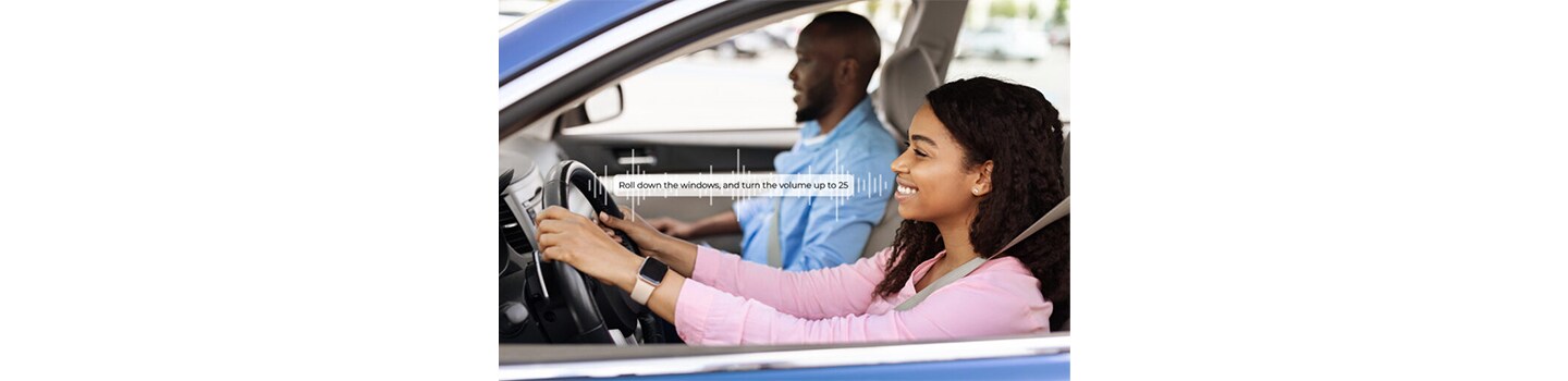 Smiling beautiful African American woman driving modern luxury car, happy young man sitting on the front passenger seat, looking on the road