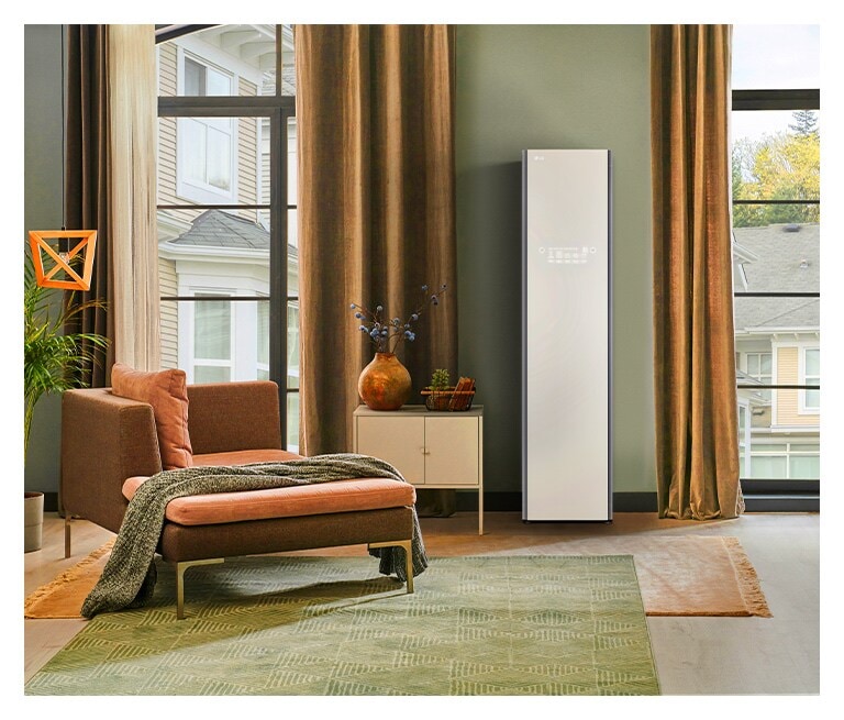 Modern living room with a brown armchair, green rug, beige curtains, and a white LG appliance next to a small table.