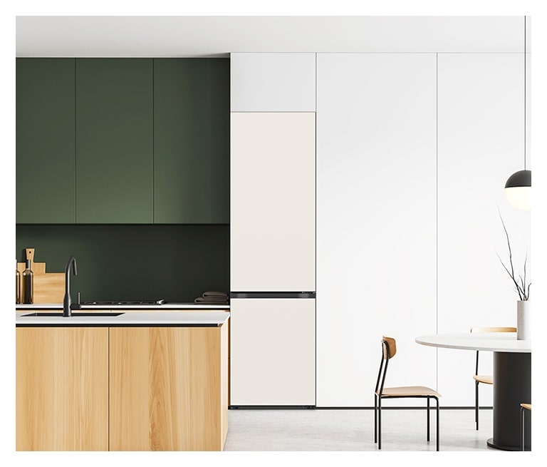 Modern kitchen with a wooden island and black faucet, green cabinets on the left, and white fridge and cabinets on the right.