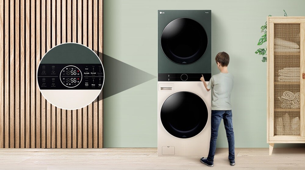 Boy using digital control panel on an LG washer and dryer in a modern laundry room with wooden slat wall and rattan cabinet.