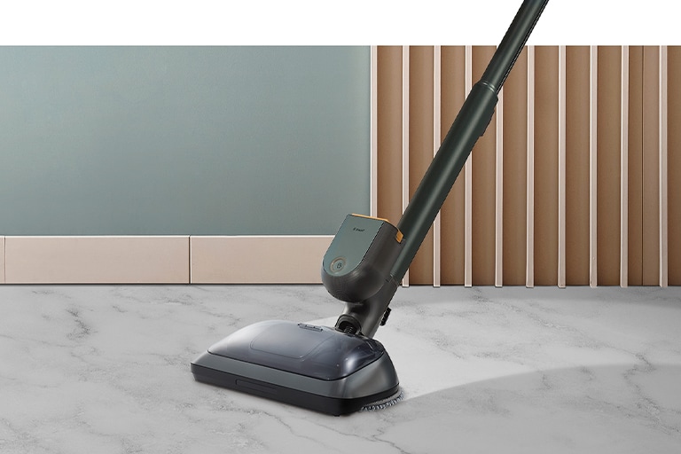 Sleek black LG cordless vacuum cleaner on light gray marble floor, beside wooden panels and a light blue wall.