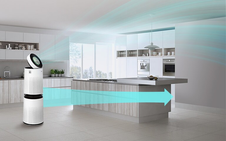 LG air purifier in a bright, modern kitchen circulates clean air, shown with blue arrows, enhancing the spacious environment.