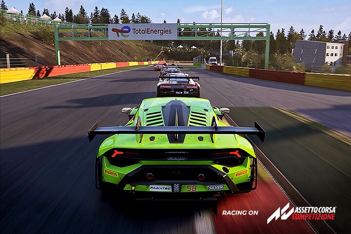 "Image of a green car racing on a track.	"