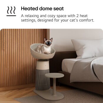 A cat sitting on a pet air purifier with a heated dome seat. The purifier is placed next to a bed, and a step accessory is positioned in front of it for easy access. Text read : 'Heated dome seat' : A relaxing and cozy space with 2 heat settings, designed for your cat's comfort.