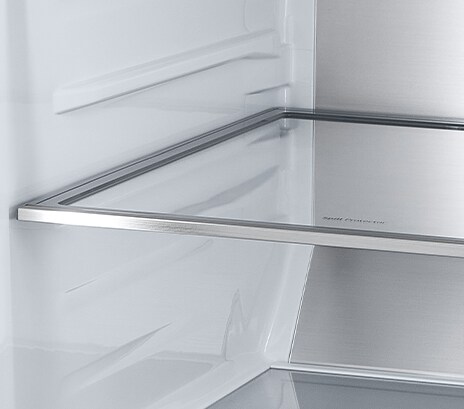 A diagonal view of the shelf with metallic paneling on the interior of the refrigerator.	