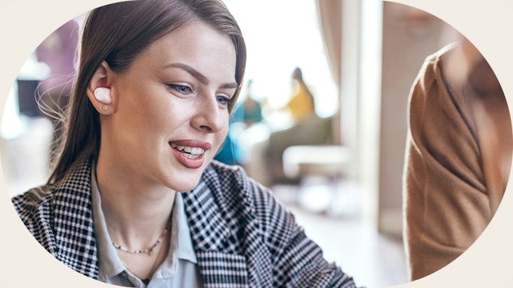 A woman wearing the T90S and using the conversation mode.