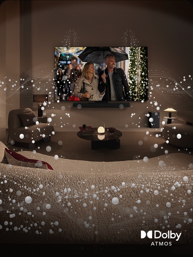 A cozy, dimly lit living space, LG OLED TV displaying a couple is using an umbrella, and bright circle graphics surround the room. Dolby Atoms logo in the bottom left corner.