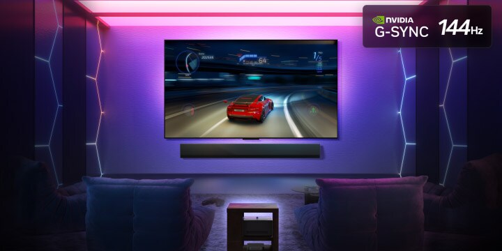 LG OLED M5 TV with a game being played on its screen showcasing the smooth and seamless gameplay. Zero Connect Box is seen, but blends well with the space. Nvidia G-Sync logo and 144Hz logo are seen. Gaming certifications are visible.