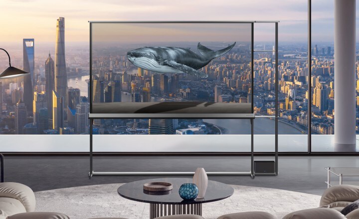 Different scenes showing the surreal visuals when the LG Signature OLED T is in transparent mode. A cityscape with fireworks, a bird picking out something from a small tree, and fishes inside a massive aquarium. All these scenes look like they're happening in real life, but it is revealed that it's just visuals coming from the LG Signature OLED T's screen, blending with the actual background in reality.
