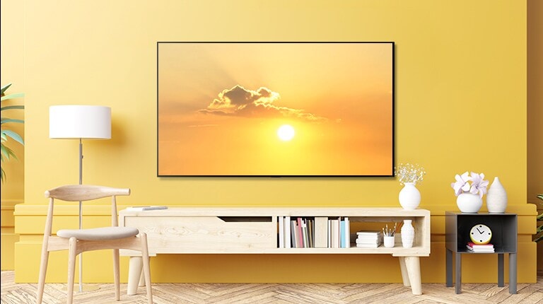 A TV in a living room shows a flying bird on yellow sky and the scene transitions to show TV placed in a bedroom that shows the same channel. 