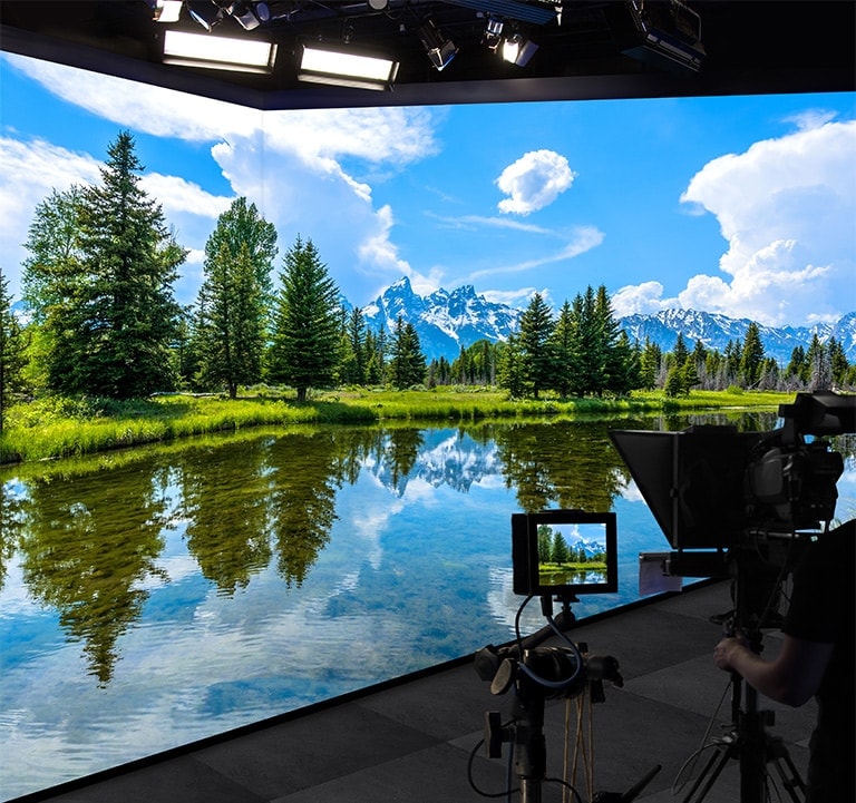 LEDs on the wall and floor vividly show the landscape and a camera is capturing the scene.