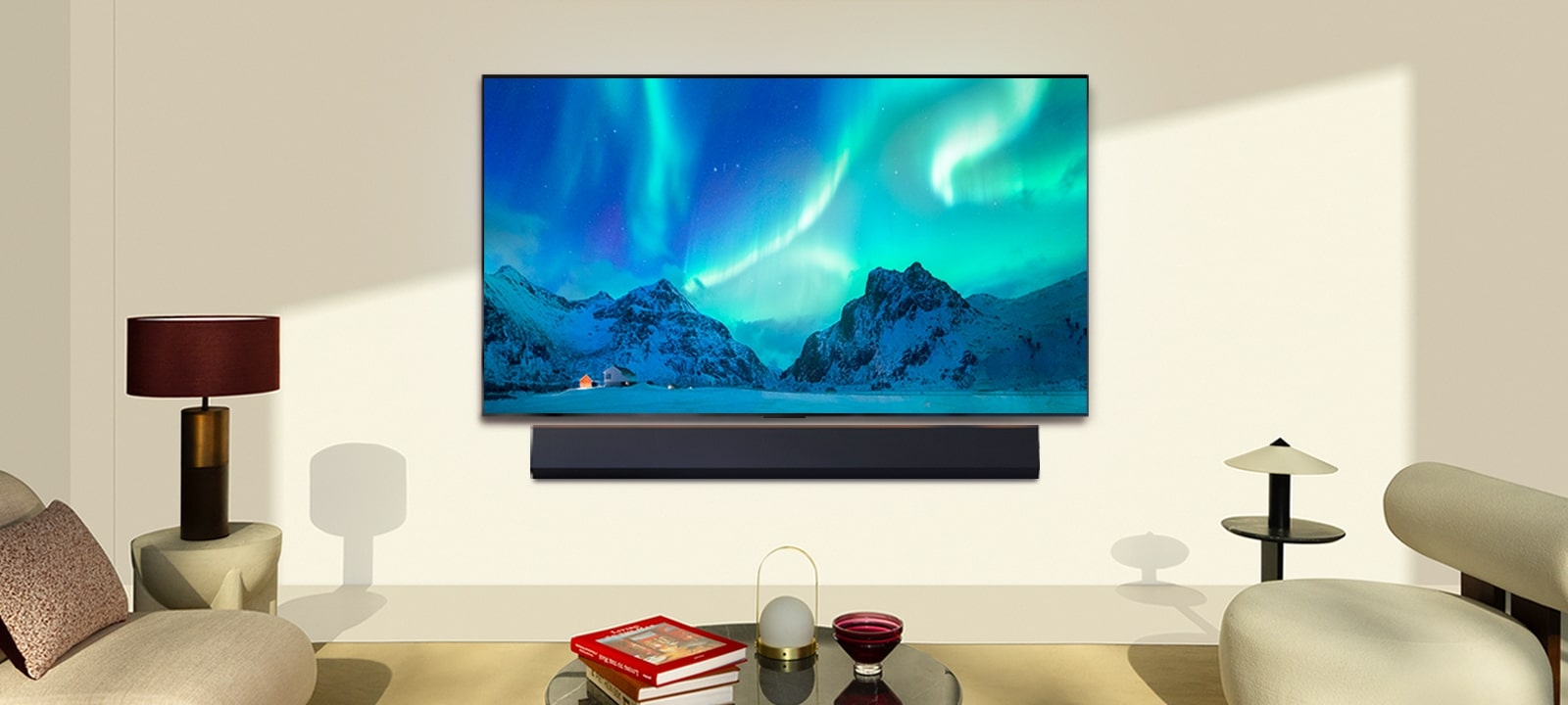 LG OLED TV and LG Soundbar in a modern living space in daytime. The screen image of the aurora borealis is displayed with the ideal brightness levels.