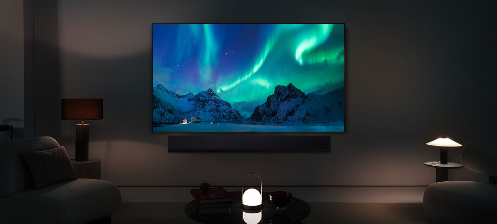 LG OLED TV and LG Soundbar in a modern living space in nighttime. The screen image of the aurora borealis is displayed with the ideal brightness levels.