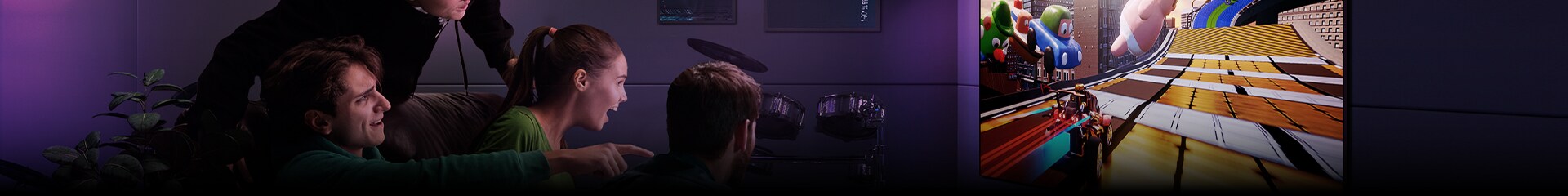 Un’immagine di tre uomini che giocano a un gioco di corse su un TV LG in un moderno appartamento in città.