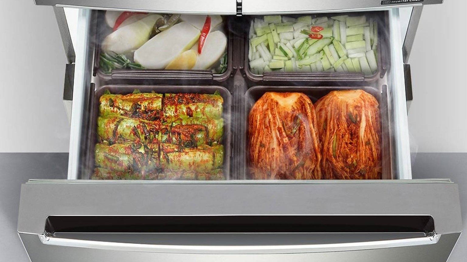 Cassetto aperto di un frigo LG con una serie di contenitori in cui sono conservate varie ricette a base di kimchi. Il frigo, in acciaio inox, è pensato per una conservazione ottimale dei cibi fermentati, mantenuti freschi e ben organizzati.