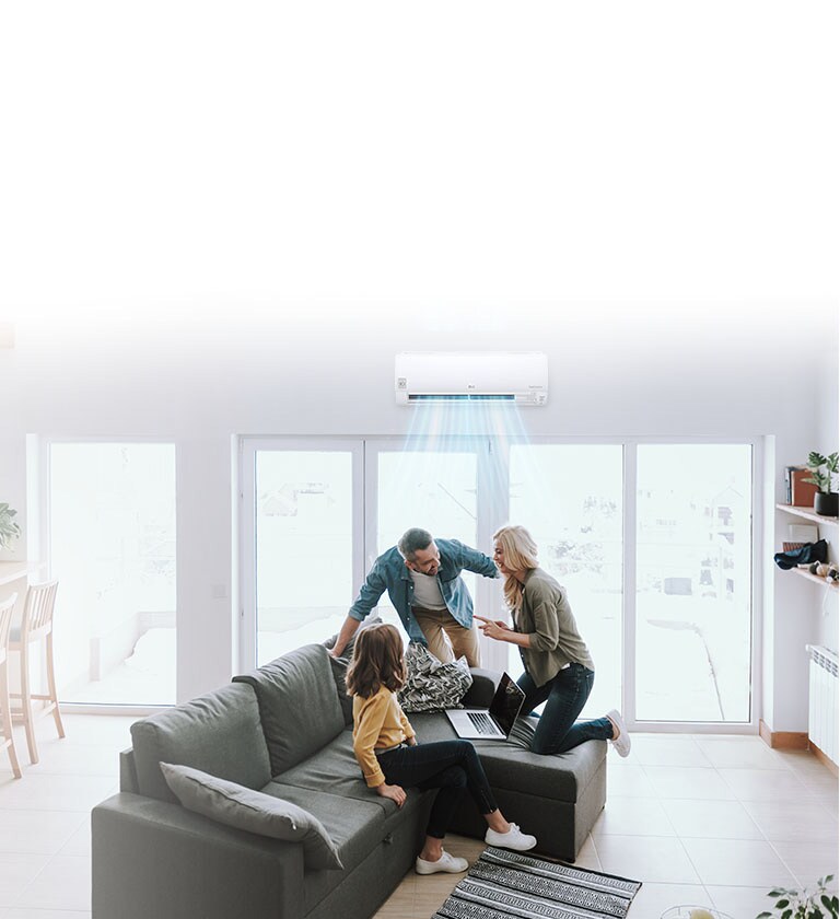 Familia en sala moderna, con LG HVAC aire acondicionado encendido, manteniendo la eficiencia energética en el hogar.