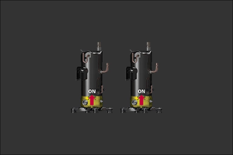 Dos compresores de frecuencia variable LG negros se colocan lado a lado. Ambos tanques están llenos de aceite amarillo hasta 1/5 de su capacidad.