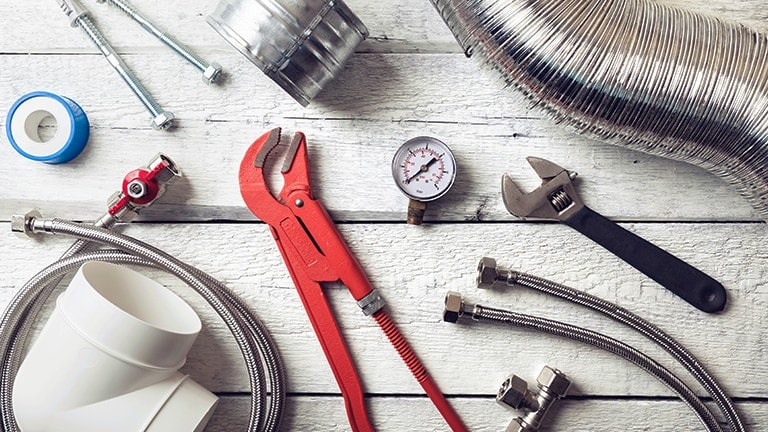 On a white wooden floor, a variety of tools and supplies are arranged, with a network monkey wrestling taking center stage.