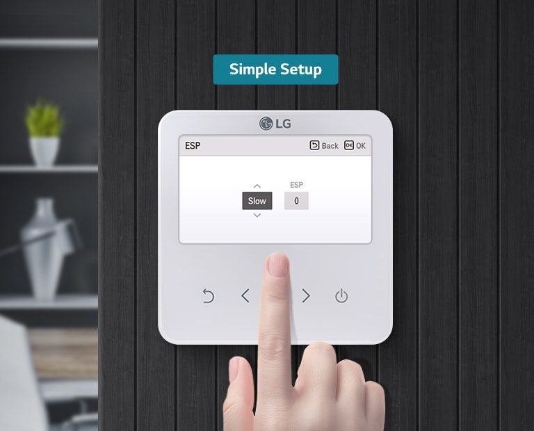 The right hand is engaging with the remote controller, which is mounted on a black wall. The controller's screen is displaying the options 'Slow' and 'ESP'.