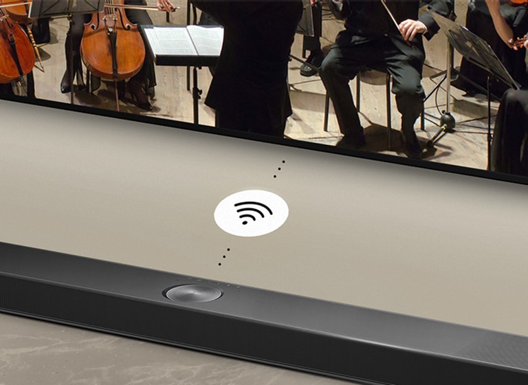 LG TV, LG Soundbar and a subwoofer are in a living room playing a musical performance. White droplets make waves of sound that shoot upwards and forward from the soundbar and project from the TV. A subwoofer is creating a sound effect from the bottom.