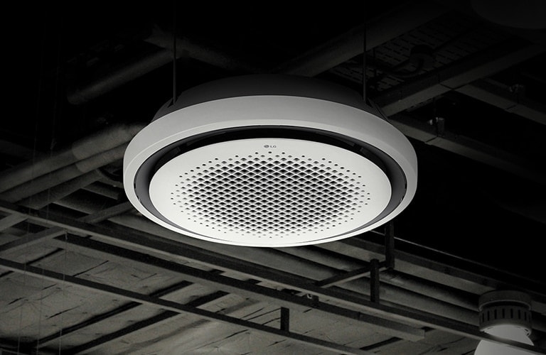 A complex network of pipes and beams adorn a black ceiling. At the center, LG Round Cassette is displayed.