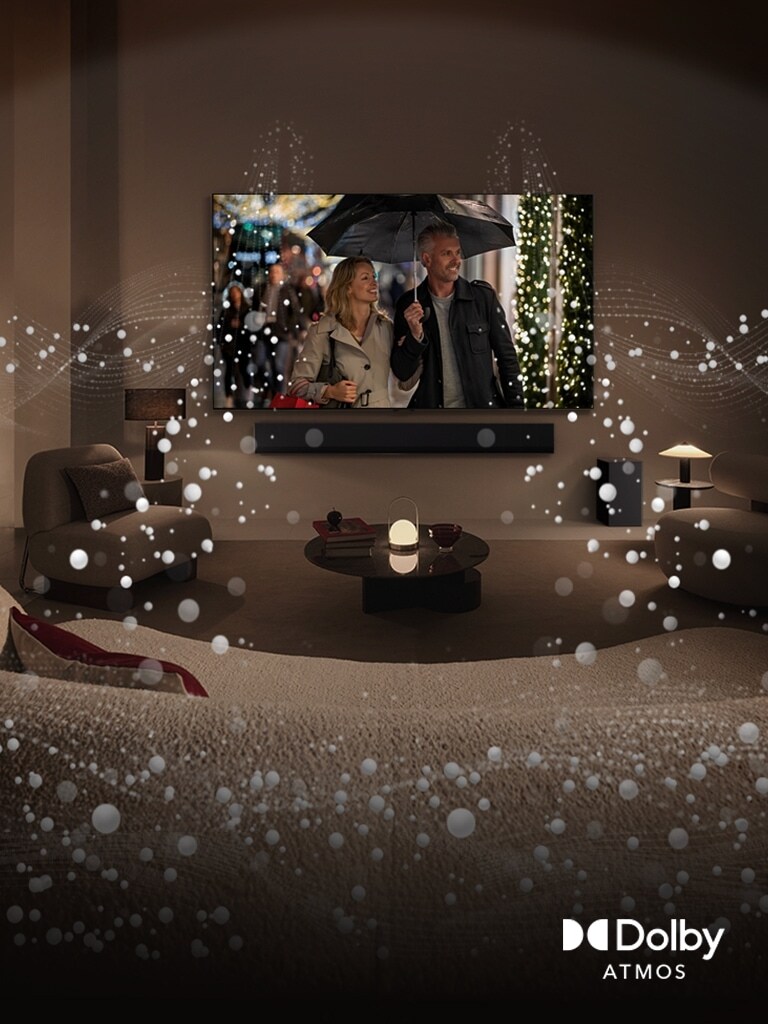 An image of a cozy, dimly lit living space. A scene is being shown on TV where a couple is using an umbrella, and bright circle graphics surround the room. Dolby atoms logo in the bottom left corner.