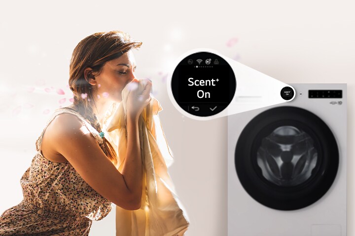 Een vrouw zit voor een wasmachine en snuift de geur van gewassen kleding op.