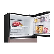 top freezer opened with moving ice maker attached and food stored