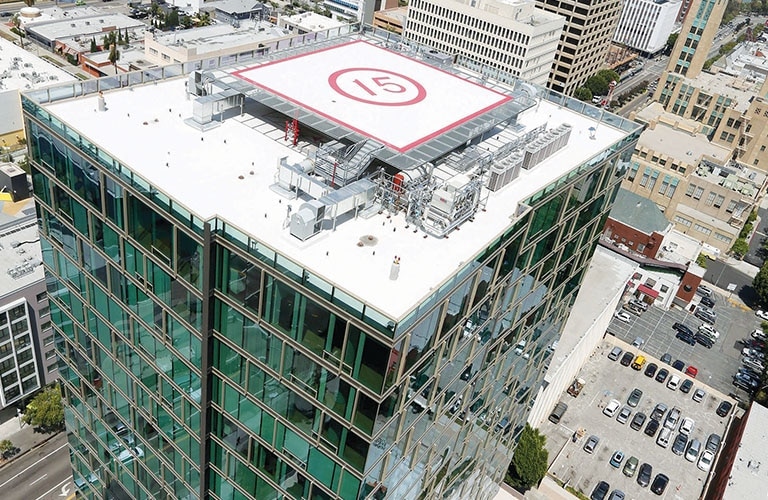 The glass-clad high-rise apartment showcases a rooftop with a centrally located heliport.