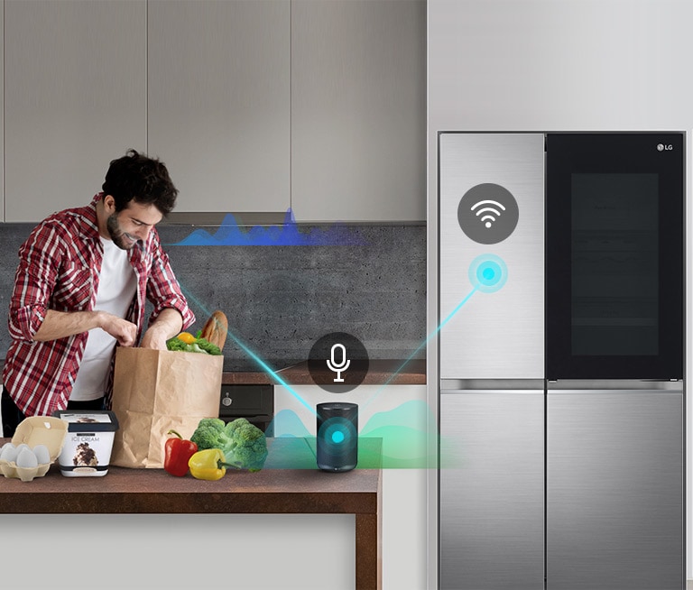 A man stands in a kitchen unloading produce from a grocery bag and speaks, shown by volume bars moving up and down near him, to the AI speaker on the counter telling it to "turn on express freeze". A line appears that goes from the man to the AI speaker which has a microphone icon above it. Then volume bars show up near the AI speaker and a line appears from the AI speaker to the refrigerator which has a Wifi icon above it.