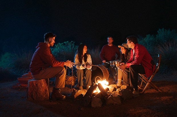 People enjoying camping with smiles, embracing the power of optimism.