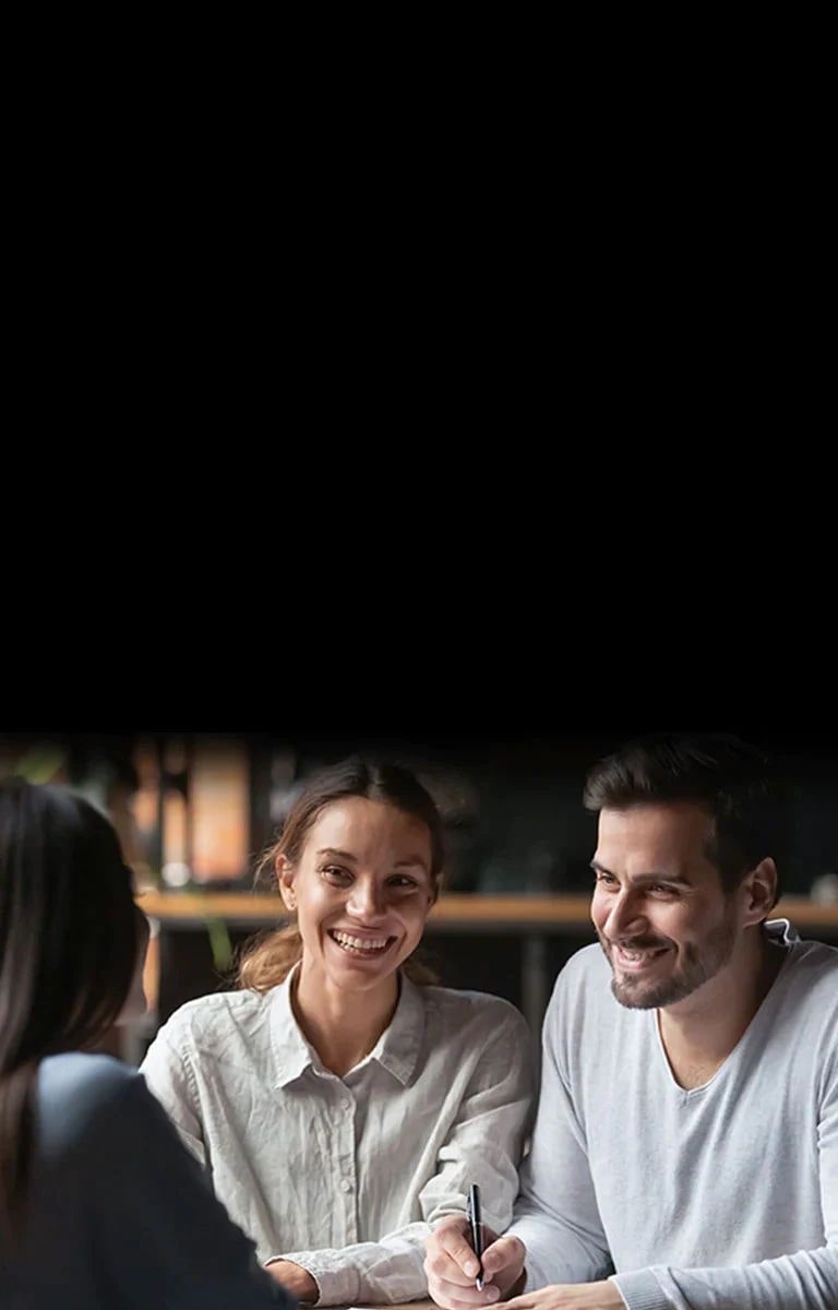 A man and a woman talk to a woman facing each other