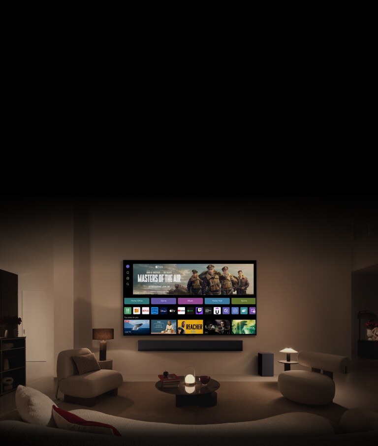 صورة مقرّبة لشاشة تلفزيون LG TV تُظهر أزرار Home Office وGame وMusic فوق لافتة لـ Masters of the Air، يتم تكبيرها لتظهر التلفزيون مثبتًا على حائط في غرفة المعيشة. تُعرض الشعارات التالية على شاشة التلفزيون في الصورة: LG Channels وNetflix وPrime Video وDisney TV وApple TV وYouTube وSpotify وTwitch وGeForce Now وUdemy.