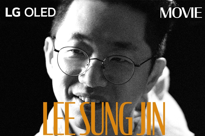 A black and white still image from an interview with Lee Sung Jin. His name appears in bold orange letters across the bottom of the frame. The phrase LG OLED is in the top left corner, and the word movie is in the top right corner.	