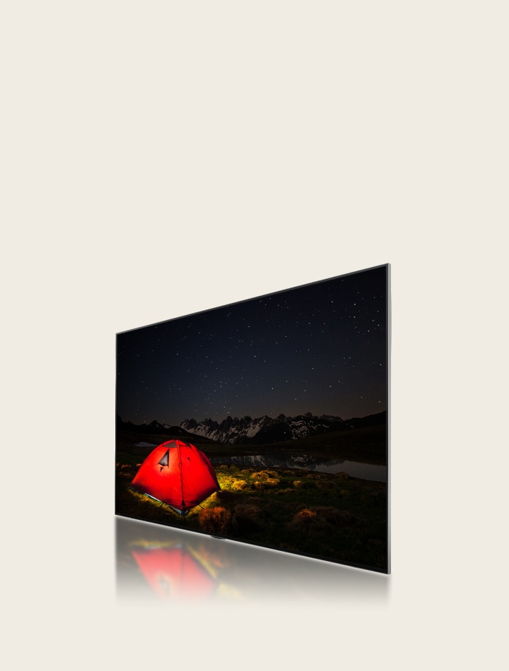 A side-angle view of an LG TV showing a dull, blurry image of a tent at night. A layer of the TV moves backward displaying big dimming areas, then smaller, blue dimming areas swipe across to replace them. The layer moves forward to reconnect to the LG TV, then the image of the tent becomes brighter and clearer.